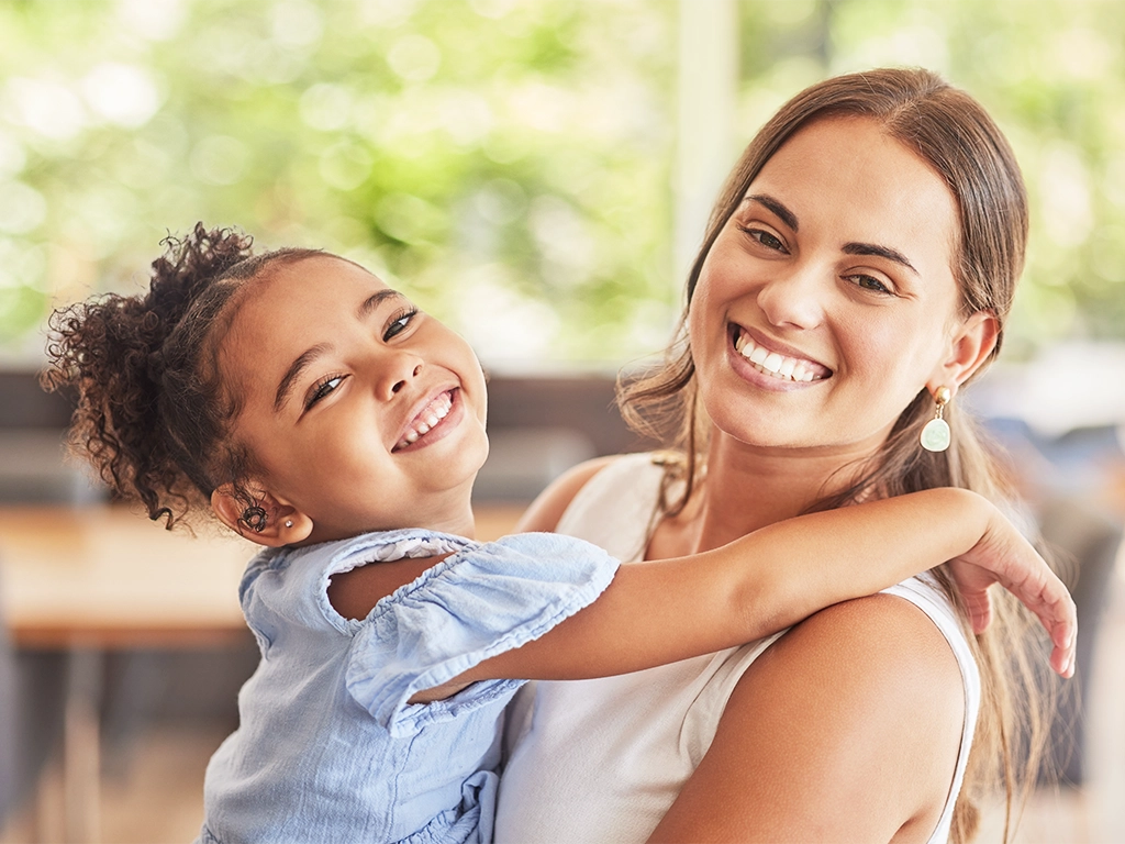 Mother and daughter smiling